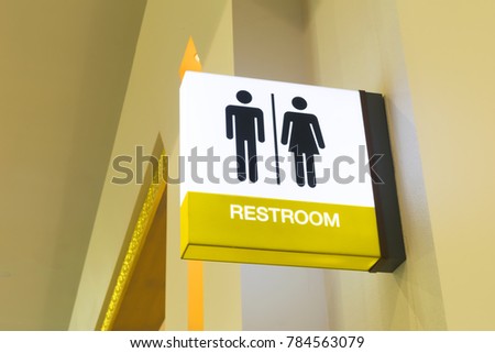 Restroom sign or toilet sign made of electric light box with man and woman icon set  symbol on white concrete wall background, modern, hygiene and clean restroom concept
