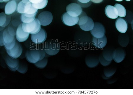 abstract blurred light blue bokeh in the dark