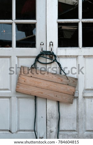 wooden signboard on the door