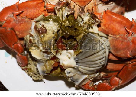 closeup steamed crab without shell in white disk. selective focus at boiled and eggs crab at center image.