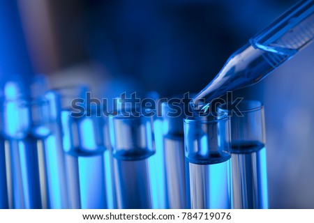Laboratory beakers, microscope, pipette. Science experiment concept background.  Royalty-Free Stock Photo #784719076