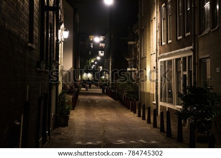 Night view of a small, narrow street in the center of Amsterdam, Holland. Royalty-Free Stock Photo #784745302