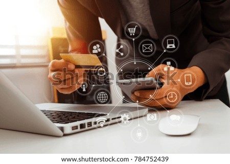 close up of hand using tablet ,laptop, and holding smartphone online banking payment communication network,internet wireless application development sync app,virtual graphic  icon diagram 
