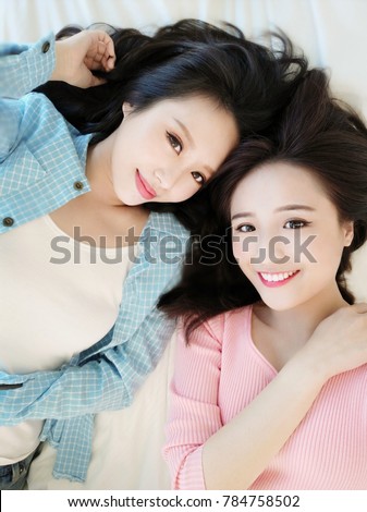 two beauty woman selfie happily on the bed