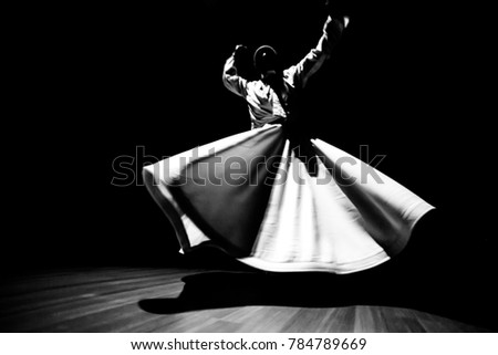 the image of a whirling Dervish in the darkness Royalty-Free Stock Photo #784789669