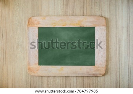 Empty green chalkboard texture hang on the wood wall. double frame from greenboard and white background. image for background, wallpaper and copy space. bill board wood frame for add text.
