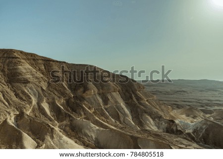 Landscape of judean desert near the dead sea in Israel. Valley of sand, mountains and stones in hot middle east tourism place. Scenic outdoor view on wild land. Summer heat and nobody on photo