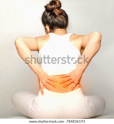 young woman in white clothes , grabbing an Waist, She has back pain. Waist pain And Care Concept.