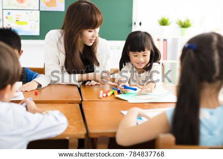 teacher and children drawing in the classroom 