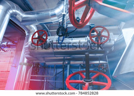 Equipment, cables and piping as found inside of a modern industrial power plant
