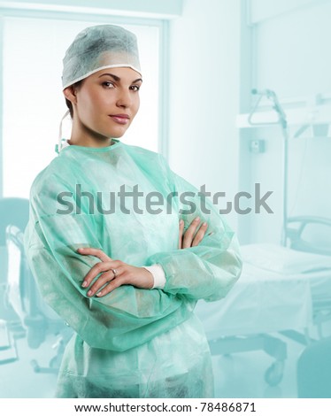 pretty nurse wearing a surgery dress with cap isolated over white looking in camera
