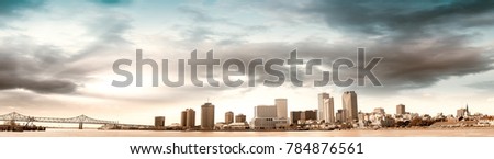 Buildings of New Orleans at sunset. Panoramic city view from Mississippi river.