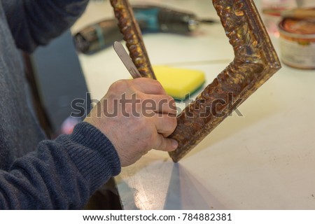 Craftsman Hands Working on Wooden Vintage Frame.