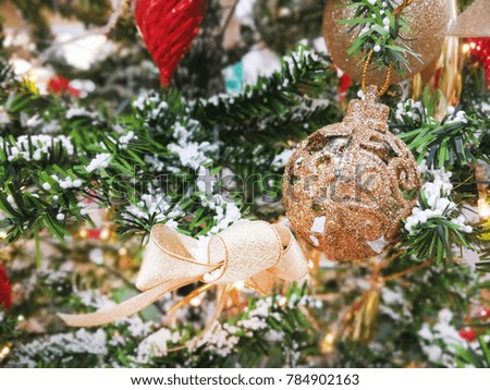 shiny christmas ornament on a Christmas tree branch