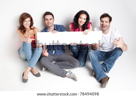 four friends showing a white board