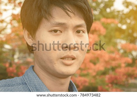 portrait young asian man on outdoor natural tree