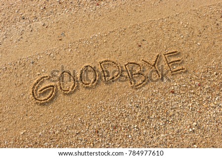 Handwriting  words "GOOD BYE" on sand of beach. Royalty-Free Stock Photo #784977610