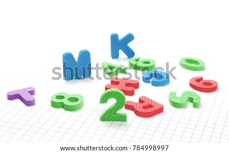 Alphabet letters and numbers pile isolated on white checkered background