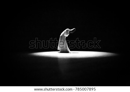 the image of a whirling Dervish in the darkness Royalty-Free Stock Photo #785007895