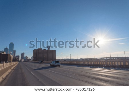 Dallas Downtown skylines from Commerce Street Bridge under cloud blue sky.