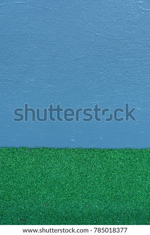 The green grass and blank blue background