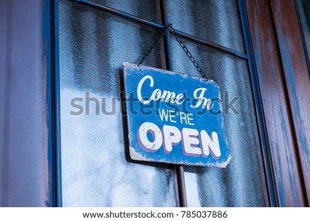Open sign on door. Rustic and vintage style. Morning time.