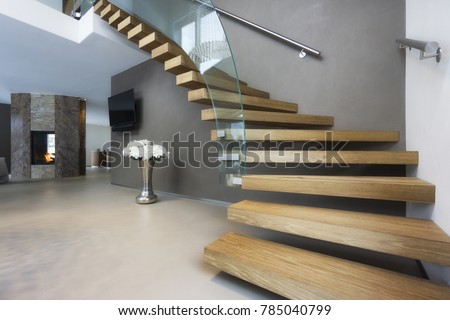 elegant wood and glass staircase in luxury home Royalty-Free Stock Photo #785040799