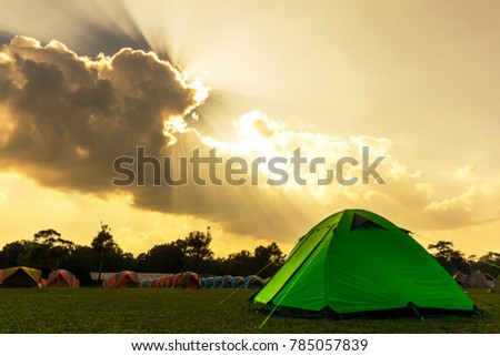 Tourist green camping tent  front of front of rental tents on the grass at campground of Phu Kradung National Park Thailand. 