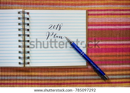 Conceptual plan - 2018 Plan words written on paper/notebook on the table.