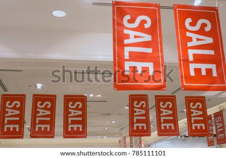 A white ceiling in a shop with a red flag to notify the sale.