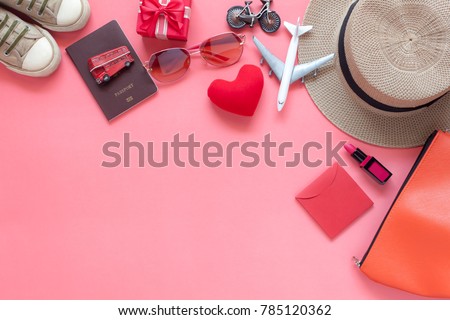 Flat lay image of accessory clothing women to plan travel in valentine's day background concept.Essential items for traveler & backpacker adult or teenage to holidays trip.Space for creative design.