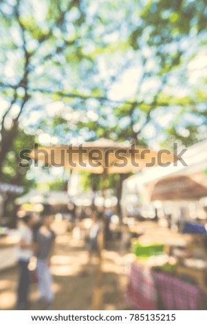 Abstract blur image of Street Day Market in garden with bokeh  for background usage .(vintage tone)
