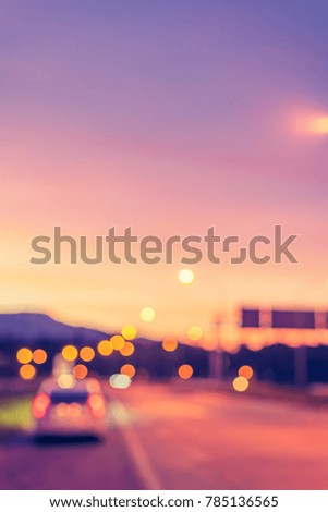 vertical image of blur car on road on evening time for background usage. (vintage tone)