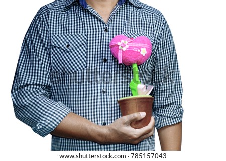 a man wear a shirt holding a pink heart shaped flower's pot  on white background isolated