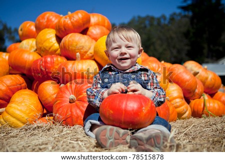 Portrait of an adorable baby boy with a pumpkin