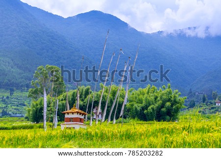Shrine and Prayer Flags in the rice field, Bhutan Royalty-Free Stock Photo #785203282