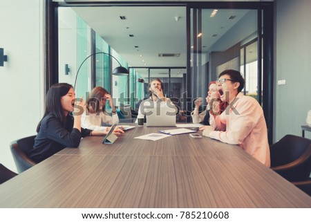 Group of business people yawning in a meeting room, sharing their ideas, Multi ethnic