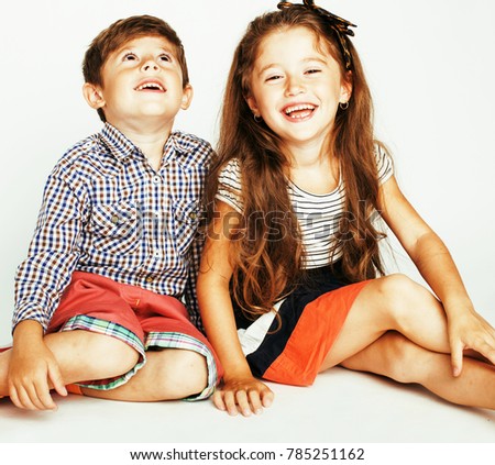 little cute boy and girl hugging playing on white background, ha