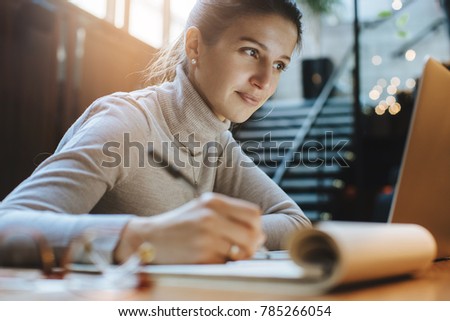 Attractive woman reading good news from business partners on laptop