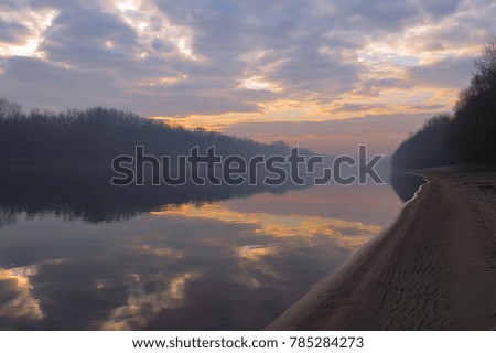          natural background. The evening bright sky reflects on the surface of the water in the river. haze                      