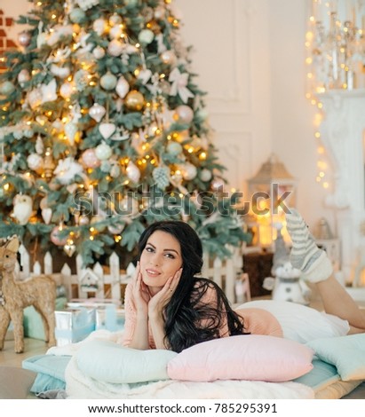 Happy young woman brunette in Christmas decorations
