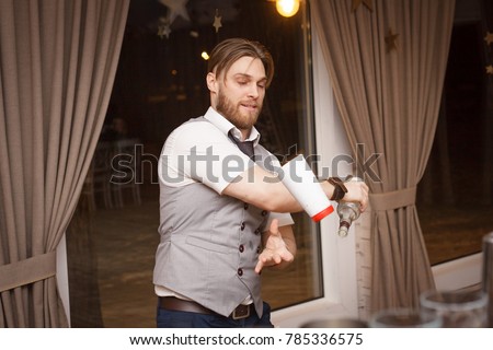 Barman make a fire show and do flairing Royalty-Free Stock Photo #785336575