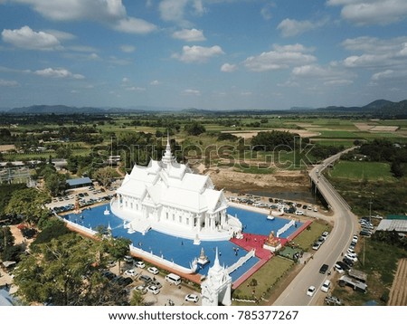 The big white church Beautiful.Wat Hin Thaen Lamphachi is located in the middle of the field at Kanchanaburi, Thailand. Website background / banner background