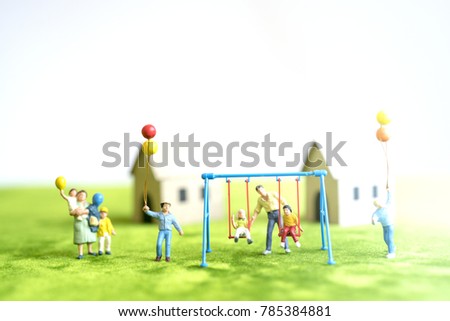 Miniature toy.Family play with parents on green grass.Family concept.