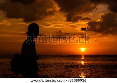A girl locking the airplane with sunset on the beach ,sunset seascape ,hope for the life concept,lowlights picture