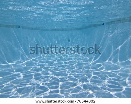 View towards the deep end of a clean swimming pool. Royalty-Free Stock Photo #78544882
