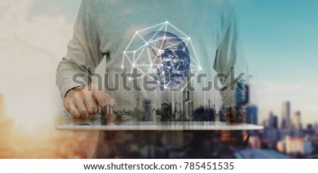 Businessman working on digital tablet with global network connection technology, city sunrise background. Element of this image are furnished by NASA