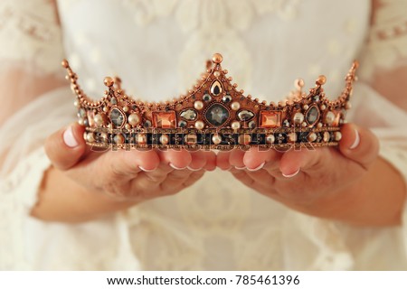 image of beautiful lady with white lace dress holding diamond crown. fantasy medieval period Royalty-Free Stock Photo #785461396