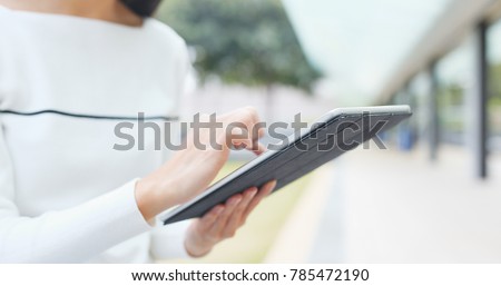 Woman touching on tablet computer at night 