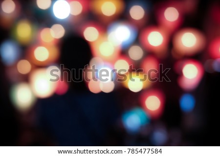 woman silhouette with beautiful light bokeh background in night time